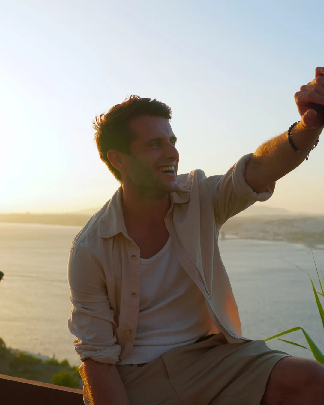 Phyles smiling in warm sunset light above Lisbon